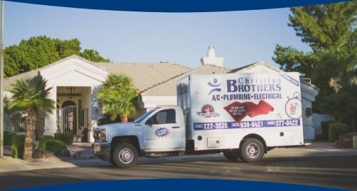 Christian Brothers van in front of house