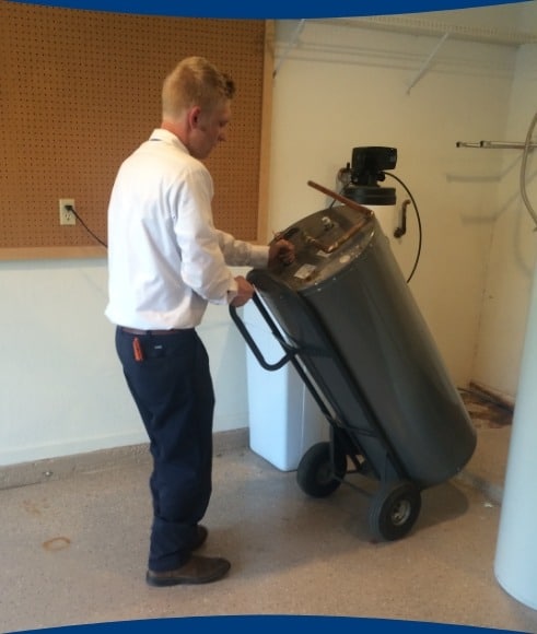 Christian Brothers employee installing a water softener